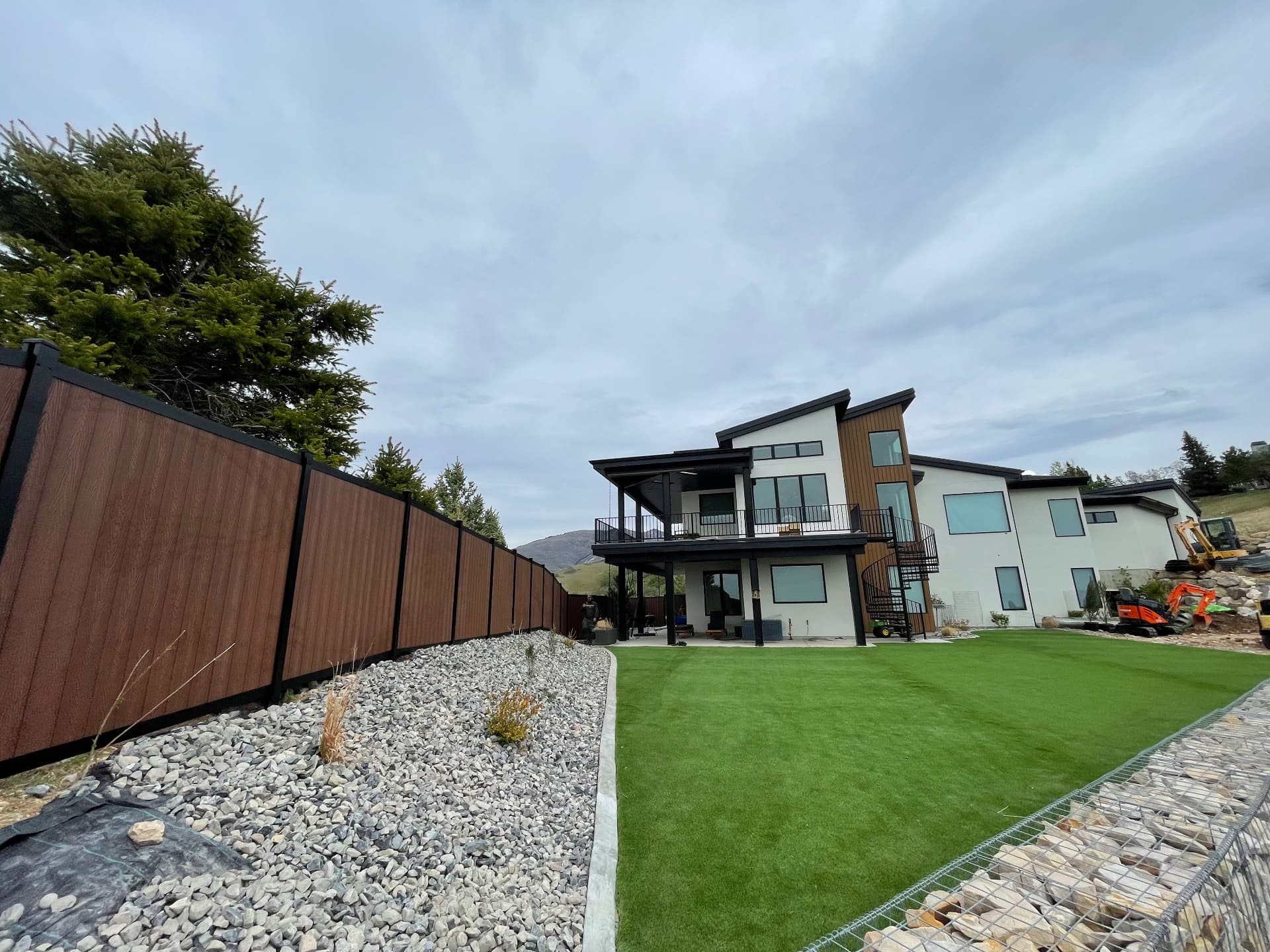 Avimore aluminum privacy fence with composite wood infill on a Utah hillside home