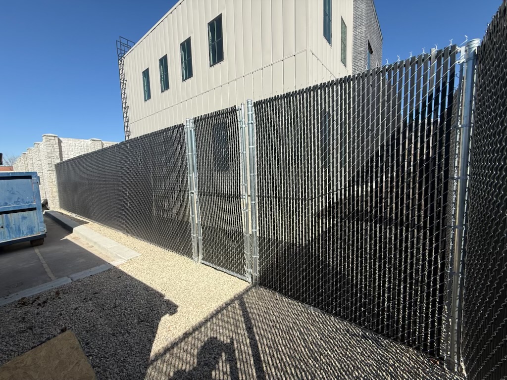 Black slat chain link security fence at a Utah commercial building