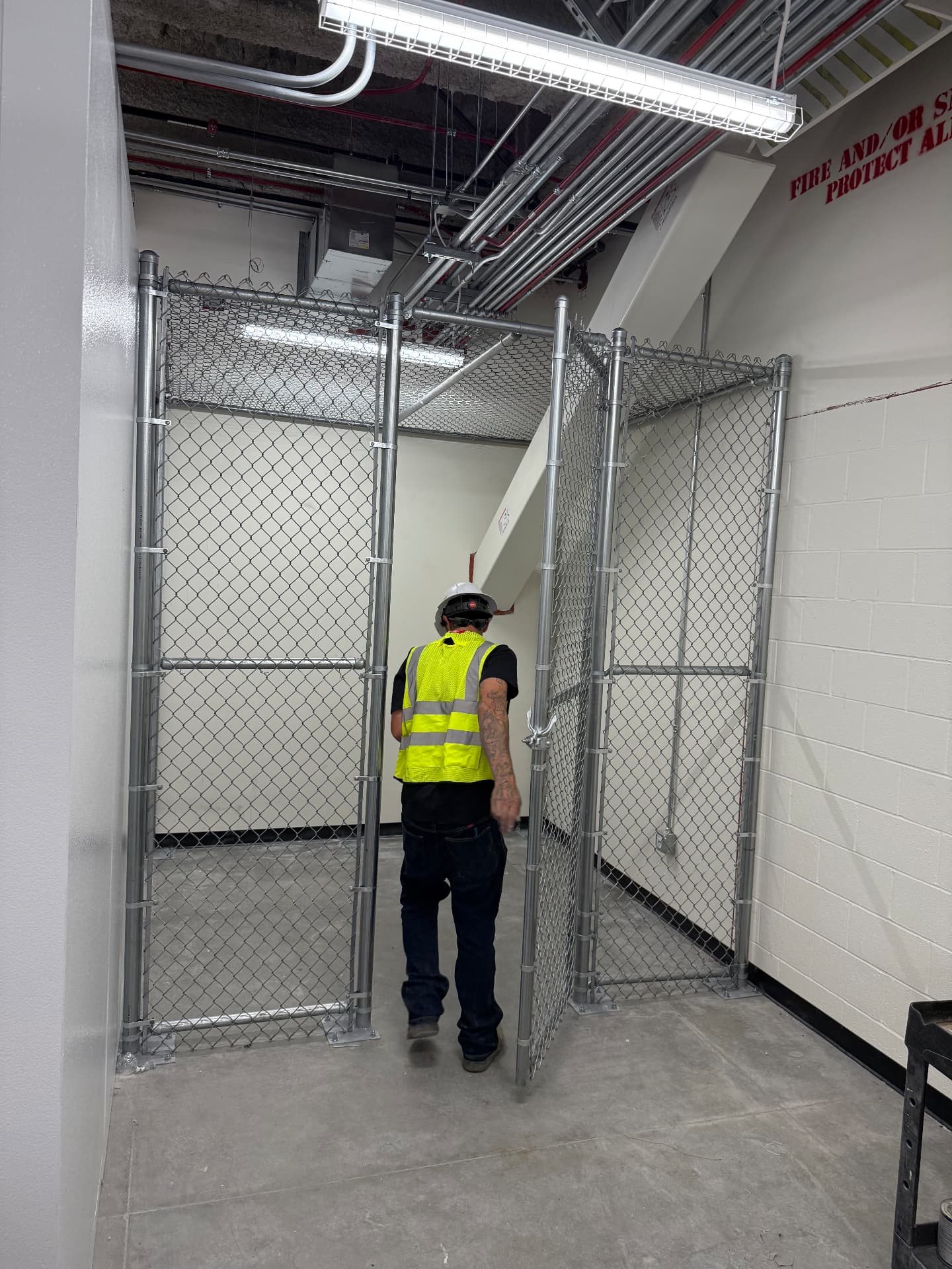 Galvanized chain link storage cage built inside a commercial building