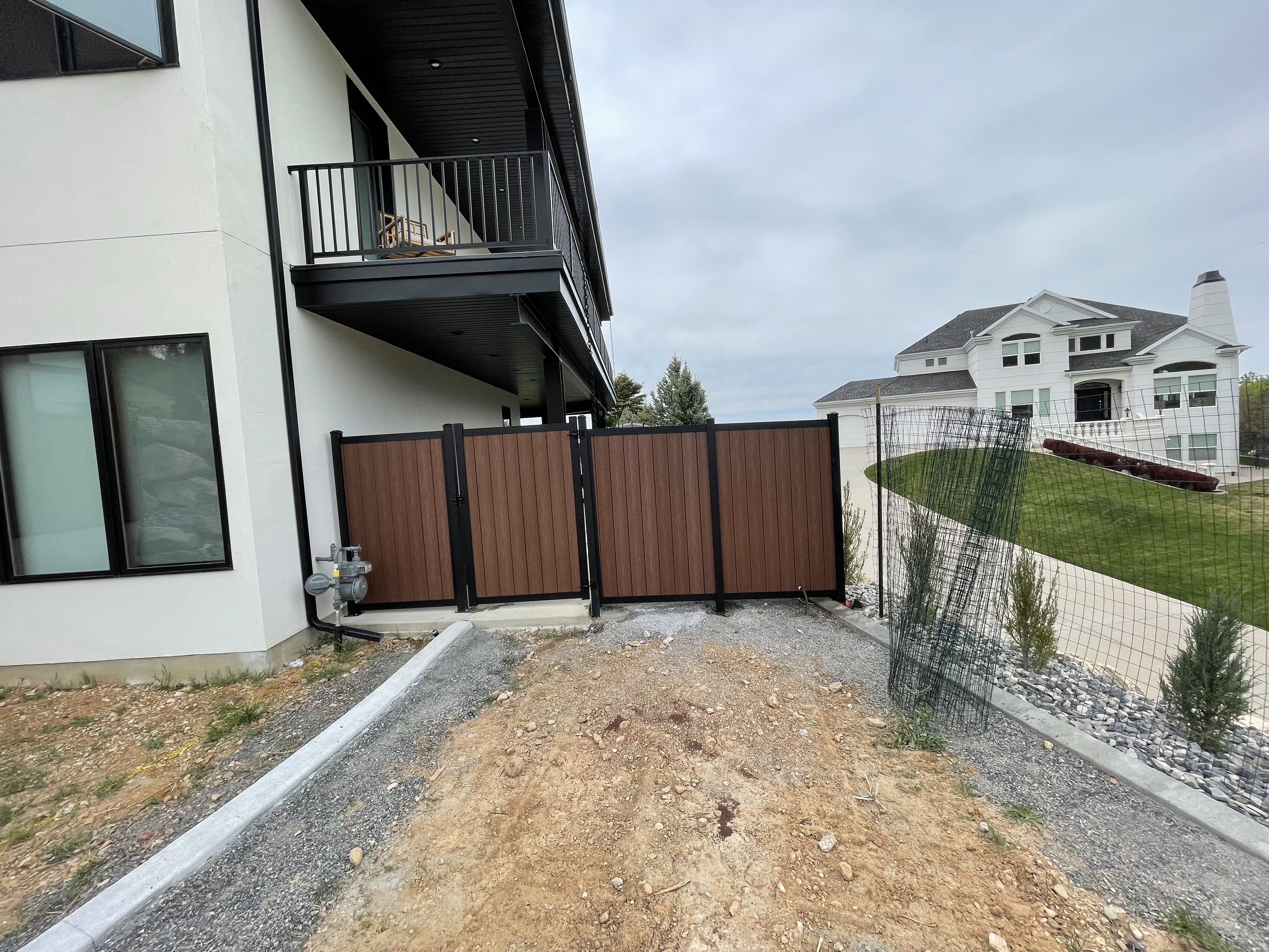 Black Avimore Aluminum with Composite Brown Wood Grain Fill installed by Spacemakers Fence in Bountiful, Utah