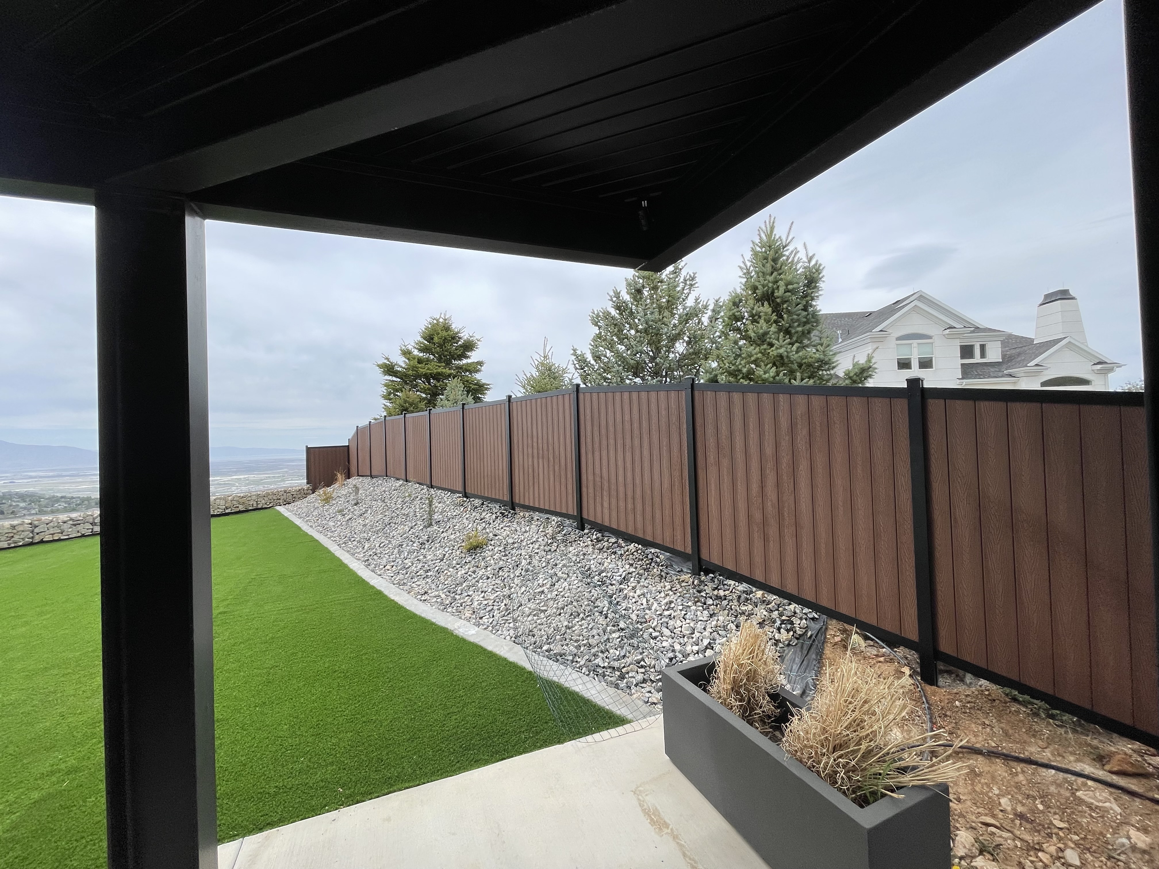Black Avimore Aluminum with Composite Brown Wood Grain Fill installed by Spacemakers Fence in Bountiful, Utah