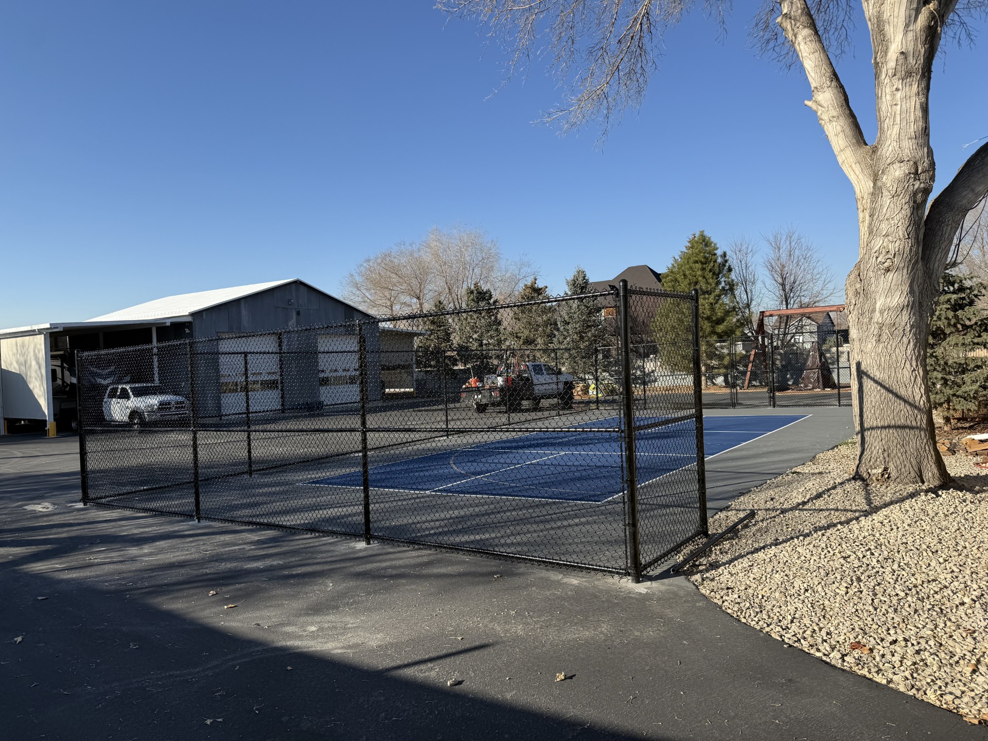 Black chain link pickleball court fence installation in Utah